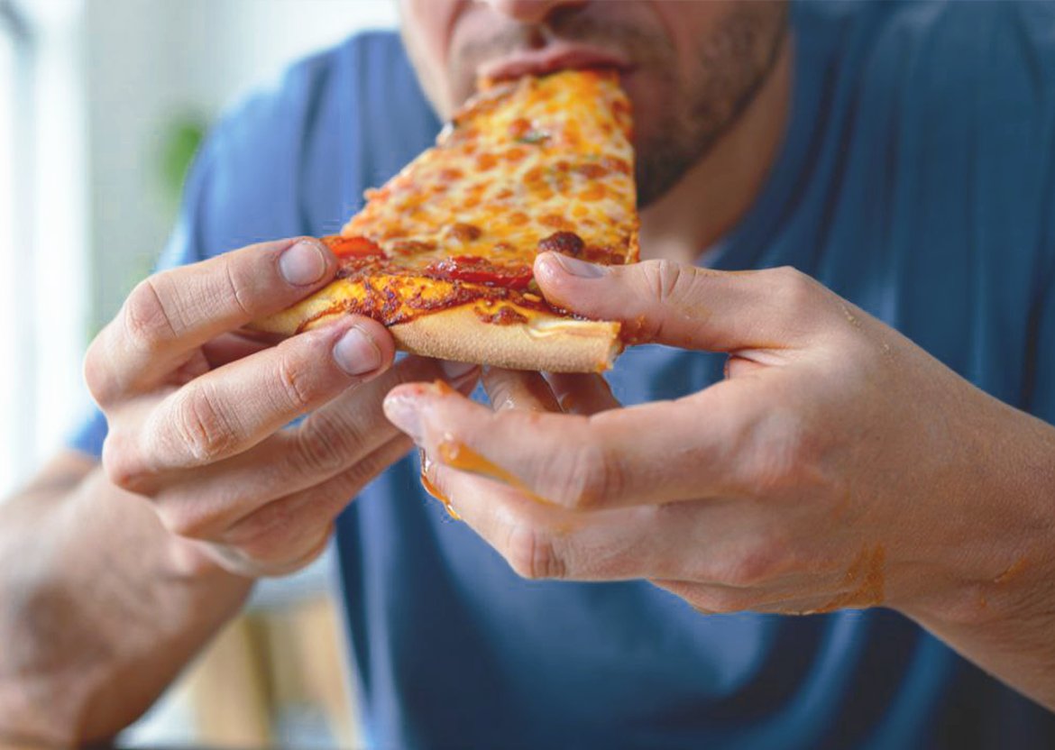 Мужчина ест пиццу